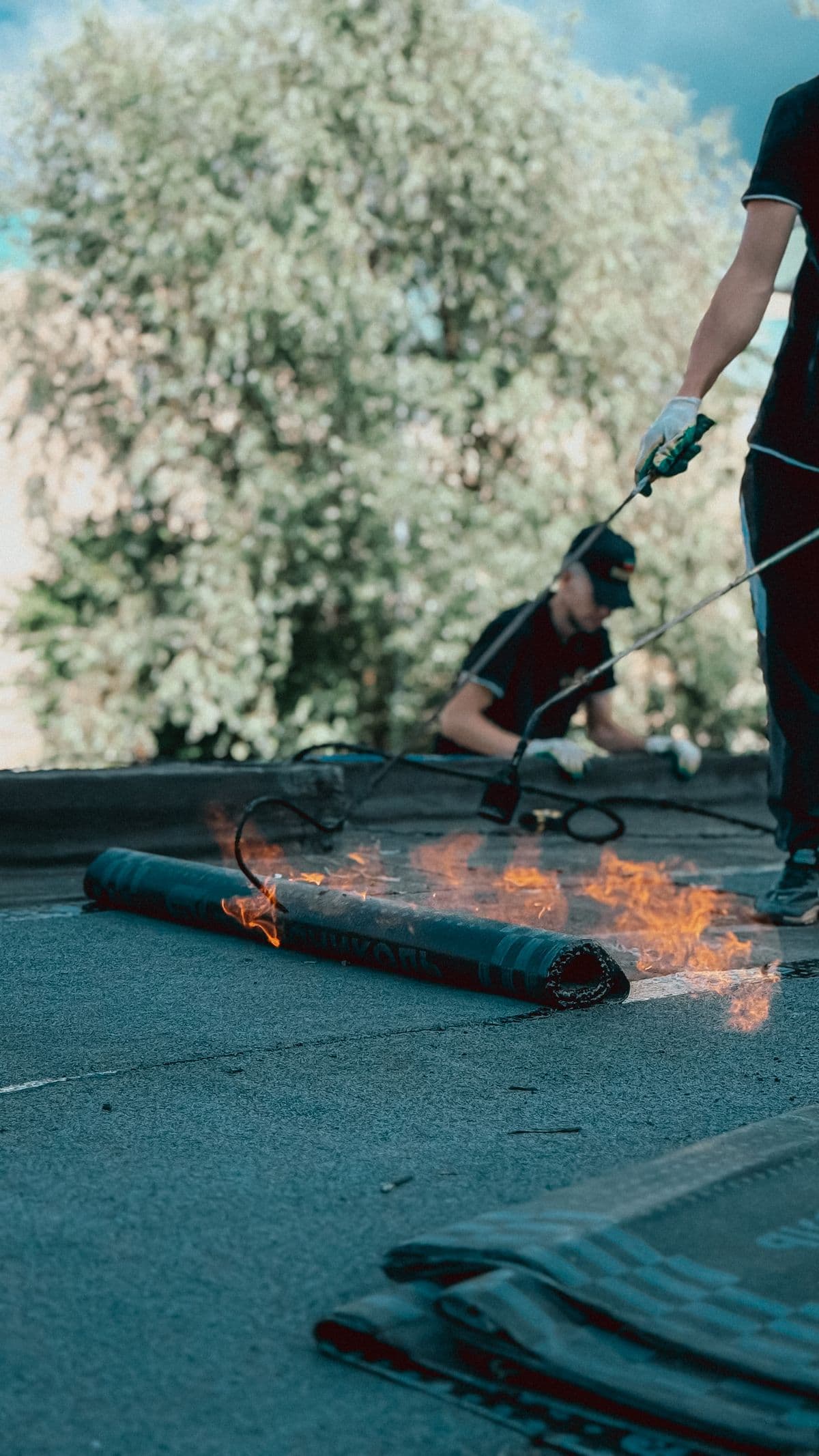 Torch-on roofing felt being applied to a flat roof